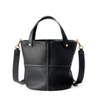 Black leather handbag with gold accents on a white background