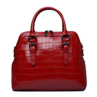 Red handbag with a textured pattern on a white background