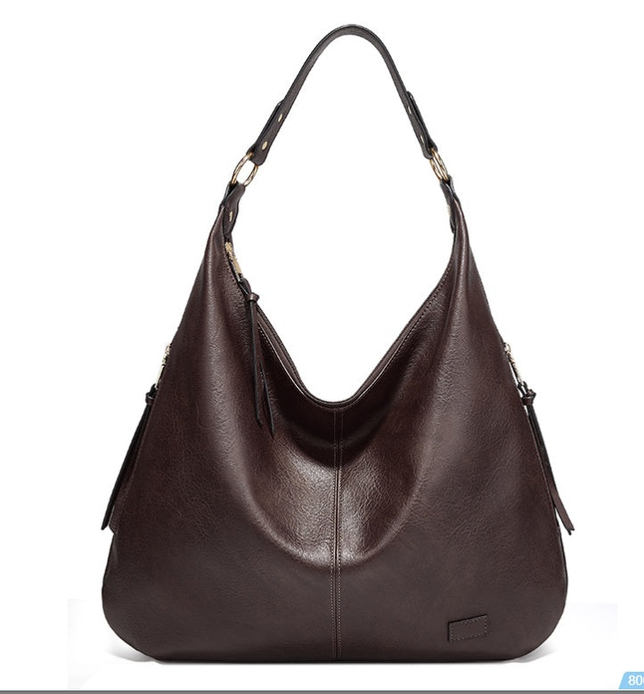 Brown leather handbag on a white background