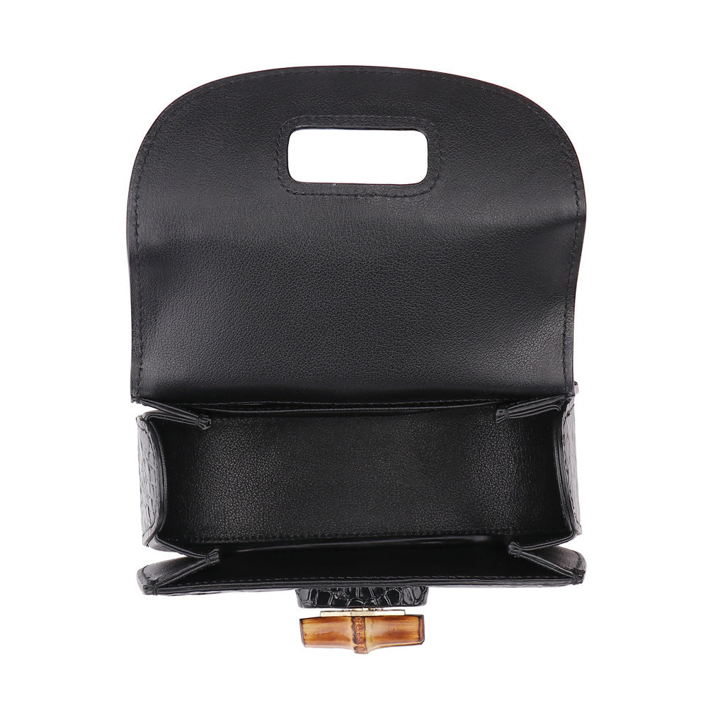 Black leather bag with a handle on a white background