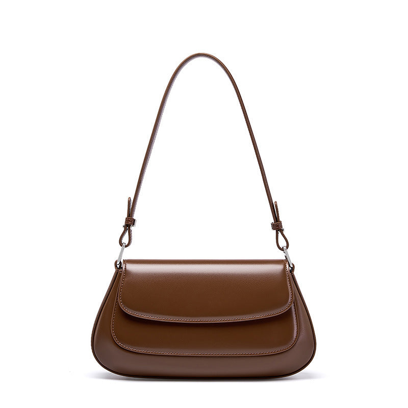 Brown handbag with a strap on a white background