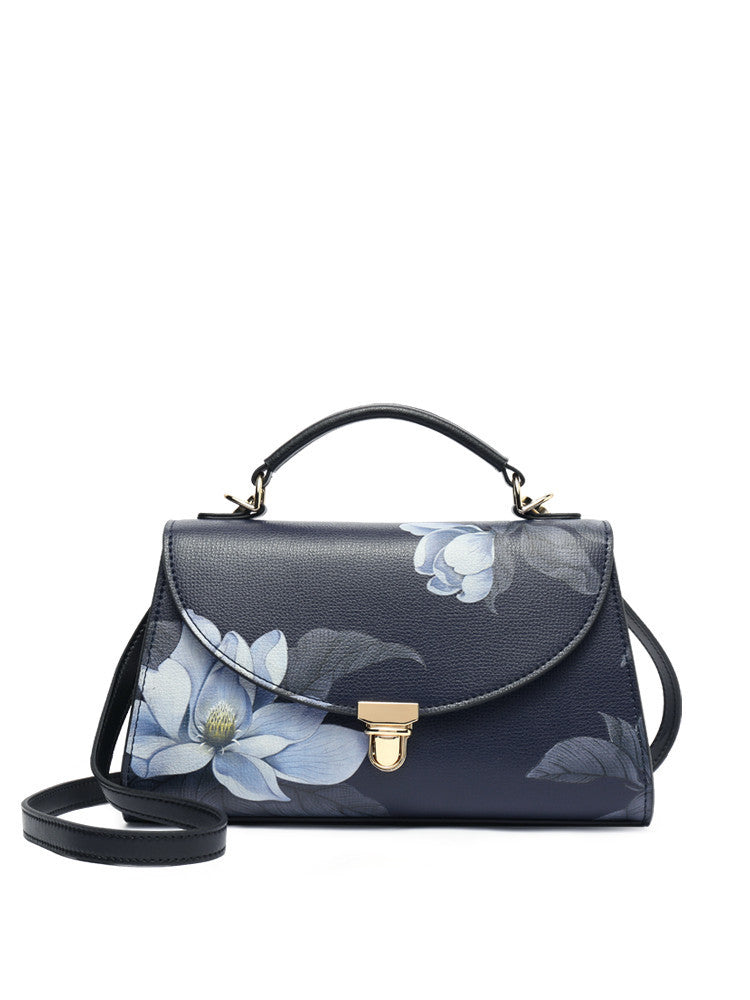 Navy handbag with floral design on a white background