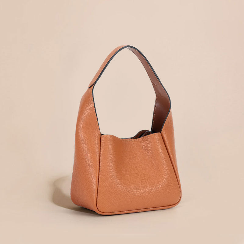 Brown leather handbag on a beige background