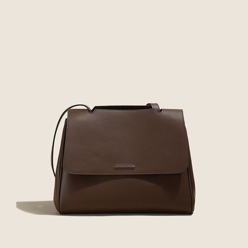 Brown leather handbag on a beige background