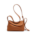 Brown leather handbag with a strap on a white background