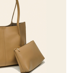 Tan leather handbag with matching pouch on a beige background