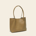Tan leather tote bag on a beige background