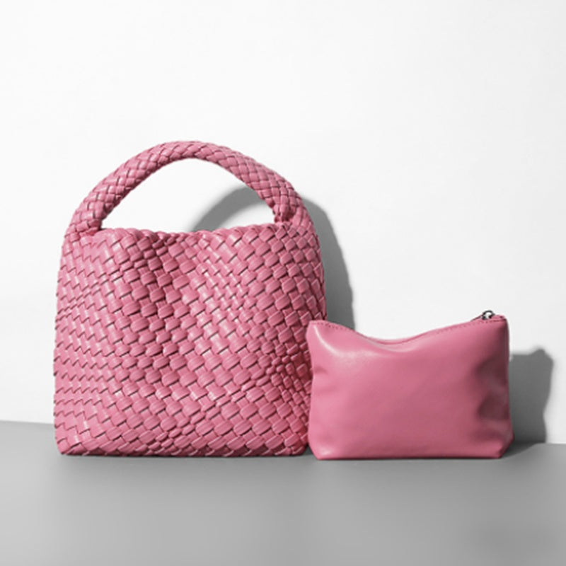 Pink woven handbag and pink pouch on a light gray background