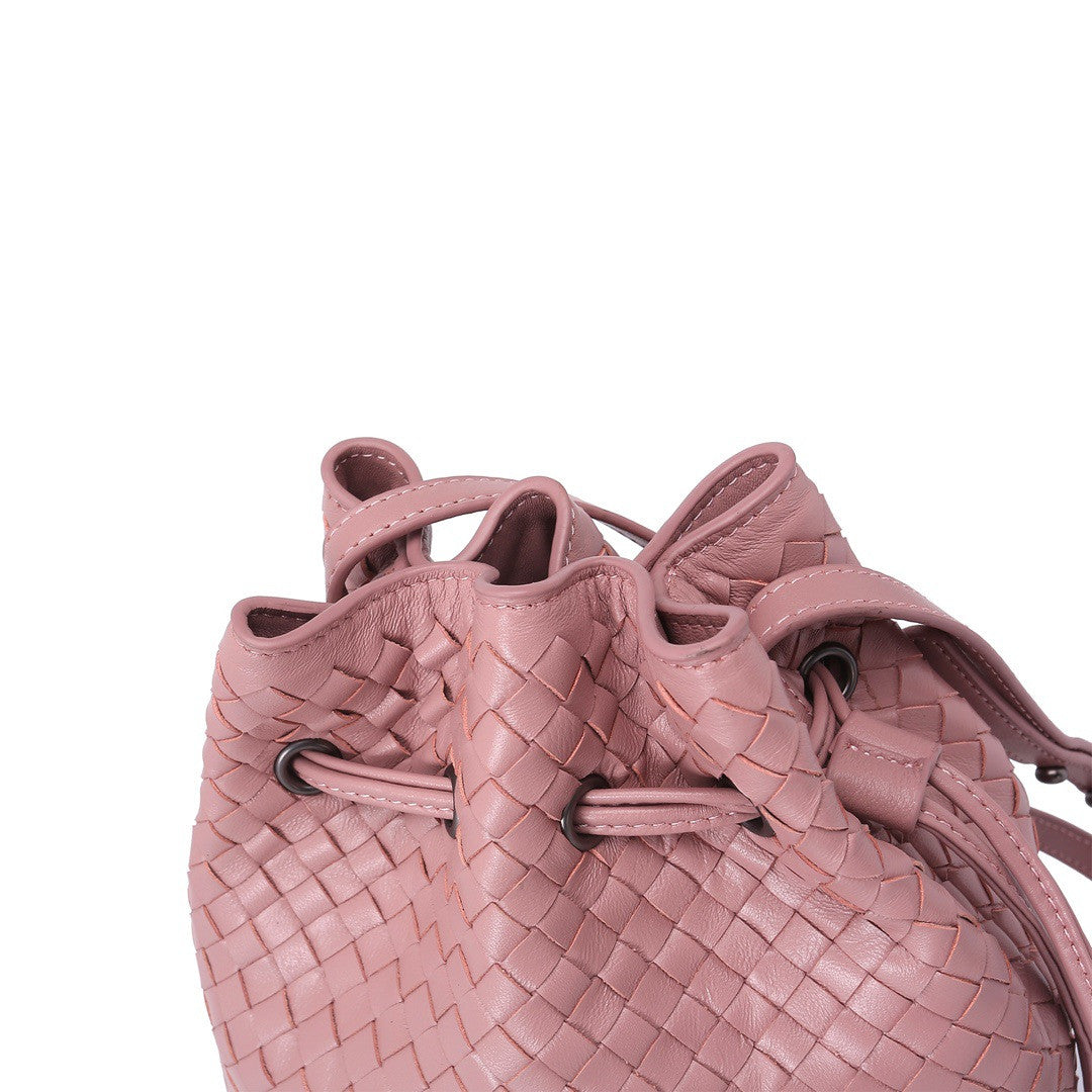 Pink woven bucket bag on a white background