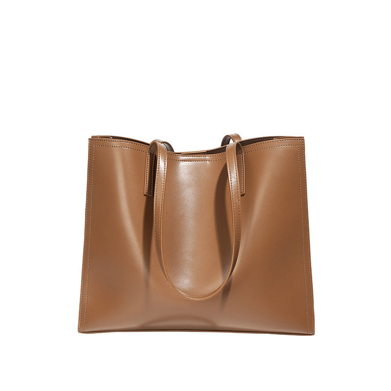 Brown leather tote bag on a white background