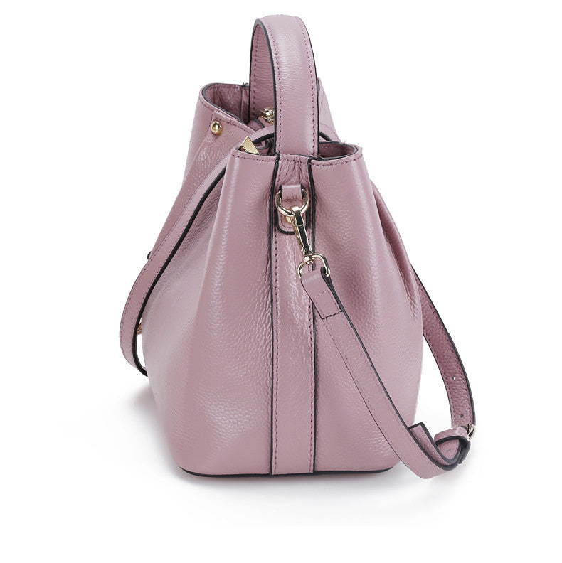 Pink handbag with a strap on a white background