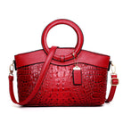 Red handbag with a textured pattern on a white background