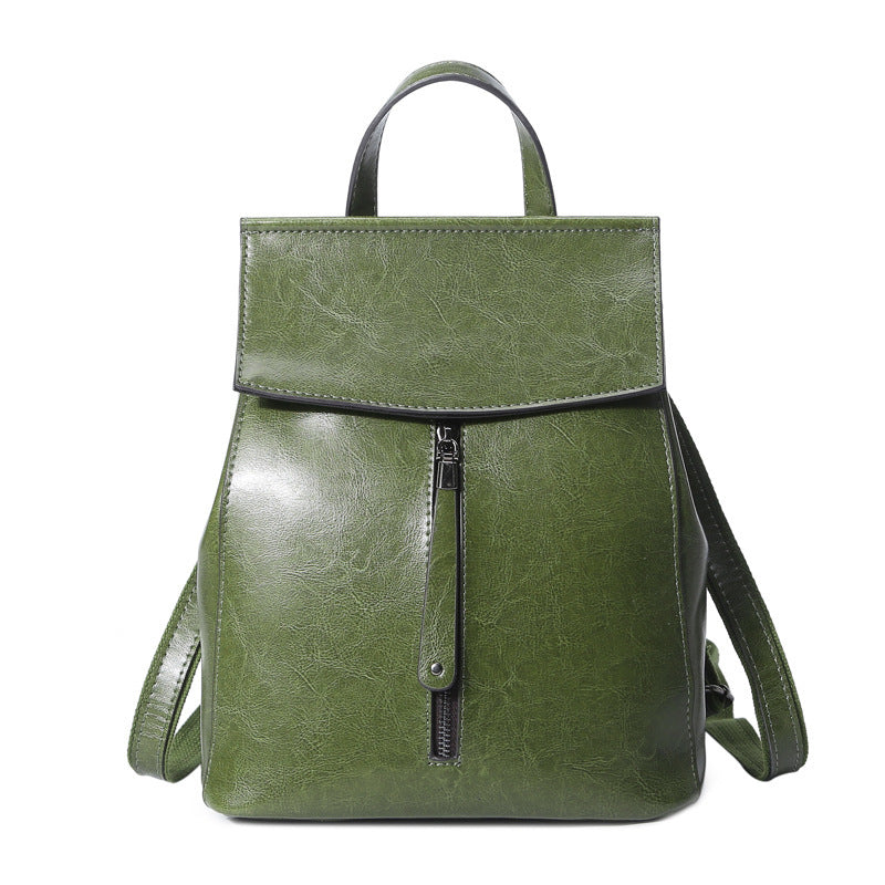 Green backpack with a zipper on a white background