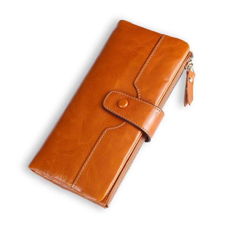 Brown leather wallet with a zipper on a white background