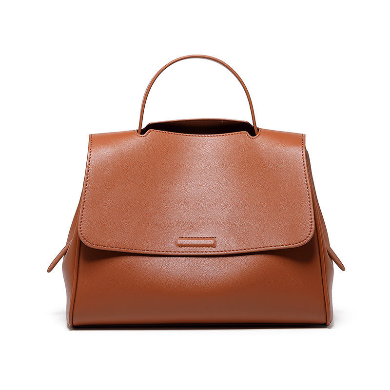 Brown leather handbag on a white background