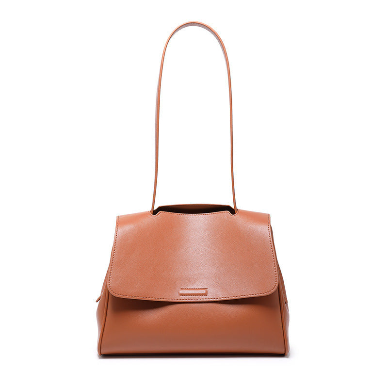 Brown leather handbag with a shoulder strap on a white background