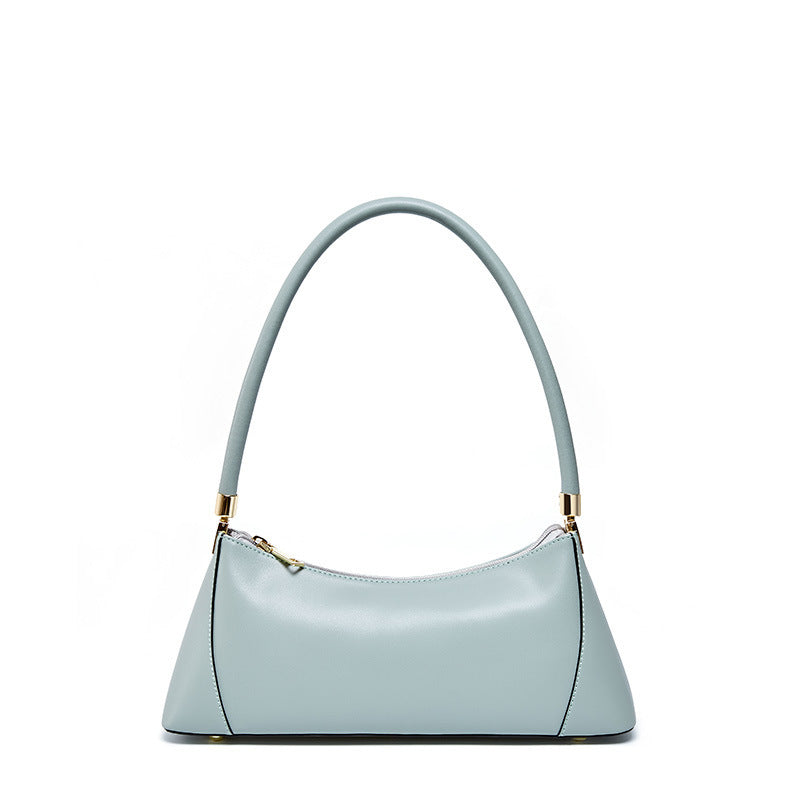 Light blue handbag with a gold zipper on a white background