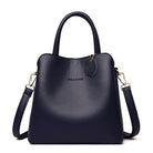 Black handbag with a shoulder strap on a white background