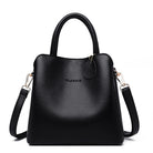 Black handbag with a shoulder strap on a white background
