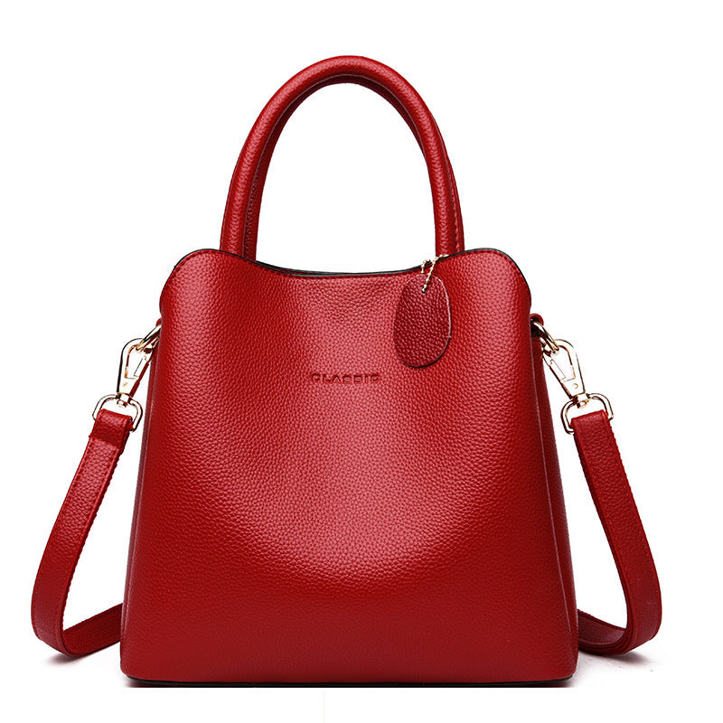 Red handbag with a visible brand logo on a white background