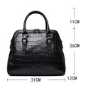 Black crocodile-patterned handbag with measurements on a white background