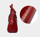 Red leather handbag with close-up of texture on a white background