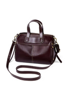 Brown leather handbag with a shoulder strap on a white background