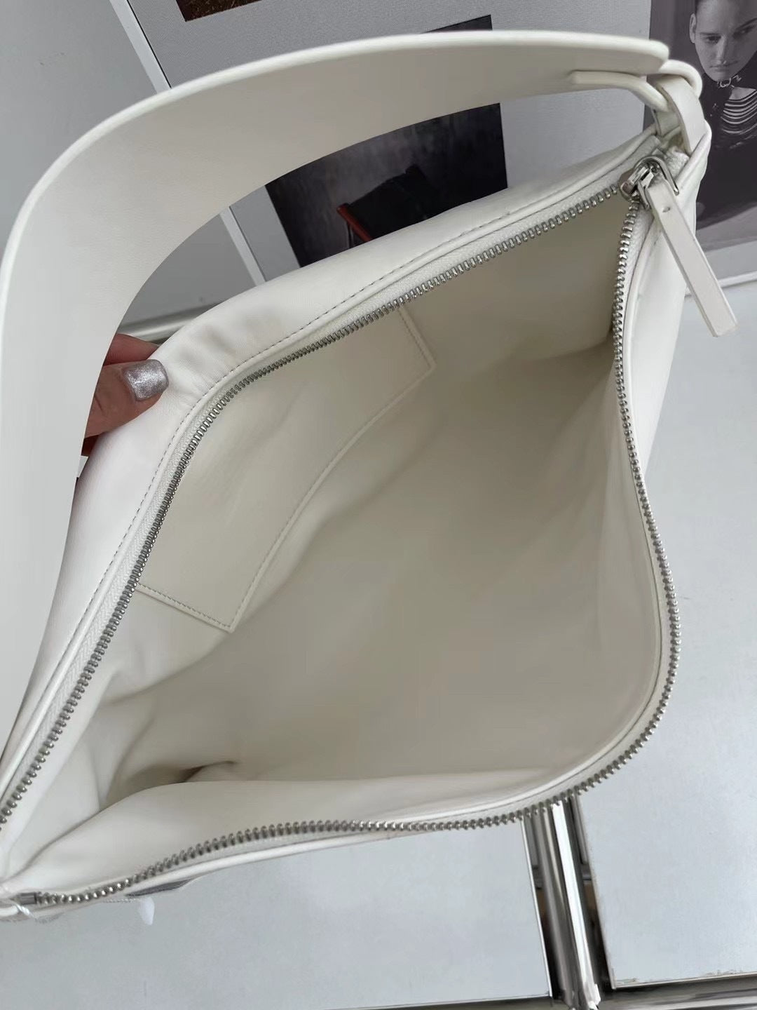 White handbag held open with a blurred background