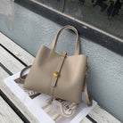 Beige handbag on a magazine with a blurred background