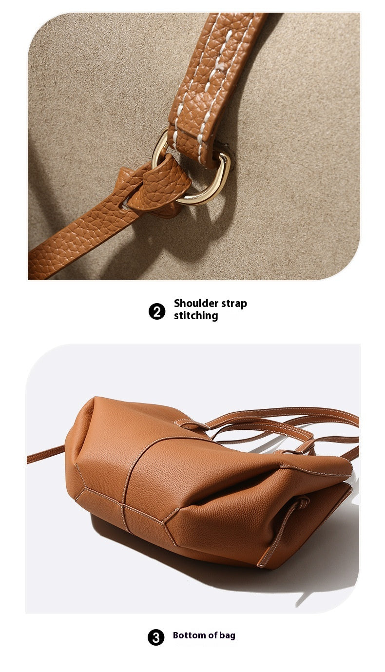 Brown leather bag with shoulder strap and stitching details on a beige background
