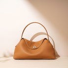 Brown handbag on a beige background