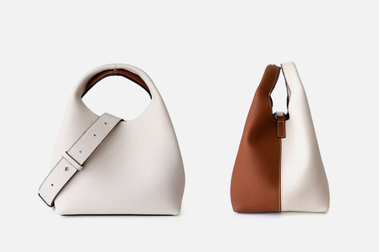 Two handbags, one white and one with a brown section, on a light gray background.