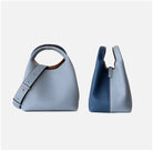 Two blue handbags on a light gray background
