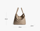 Beige handbag with measurements on a white background