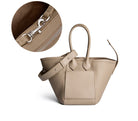 Beige handbag with close-up of zipper on a white background