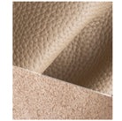 Close-up of beige leather texture with a diagonal pattern