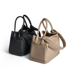 Black and beige handbags on a white background