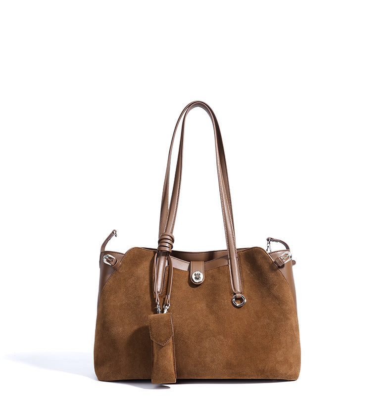 Brown handbag with a strap on a white background