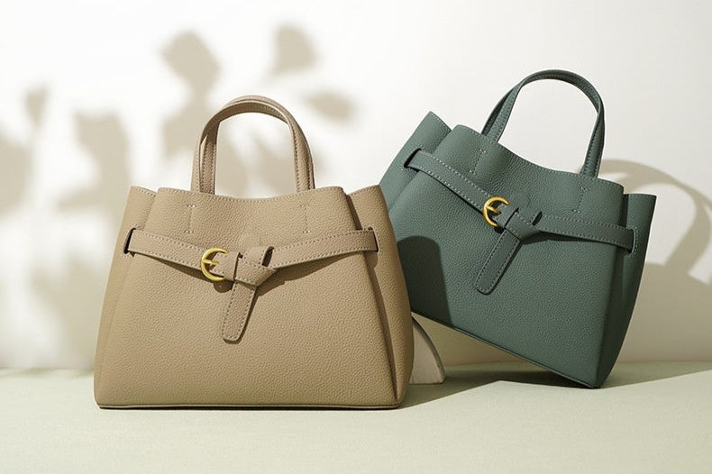 Two handbags, one beige and one green, on a light background