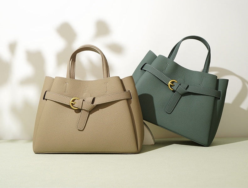 Two handbags, one beige and one green, on a light background