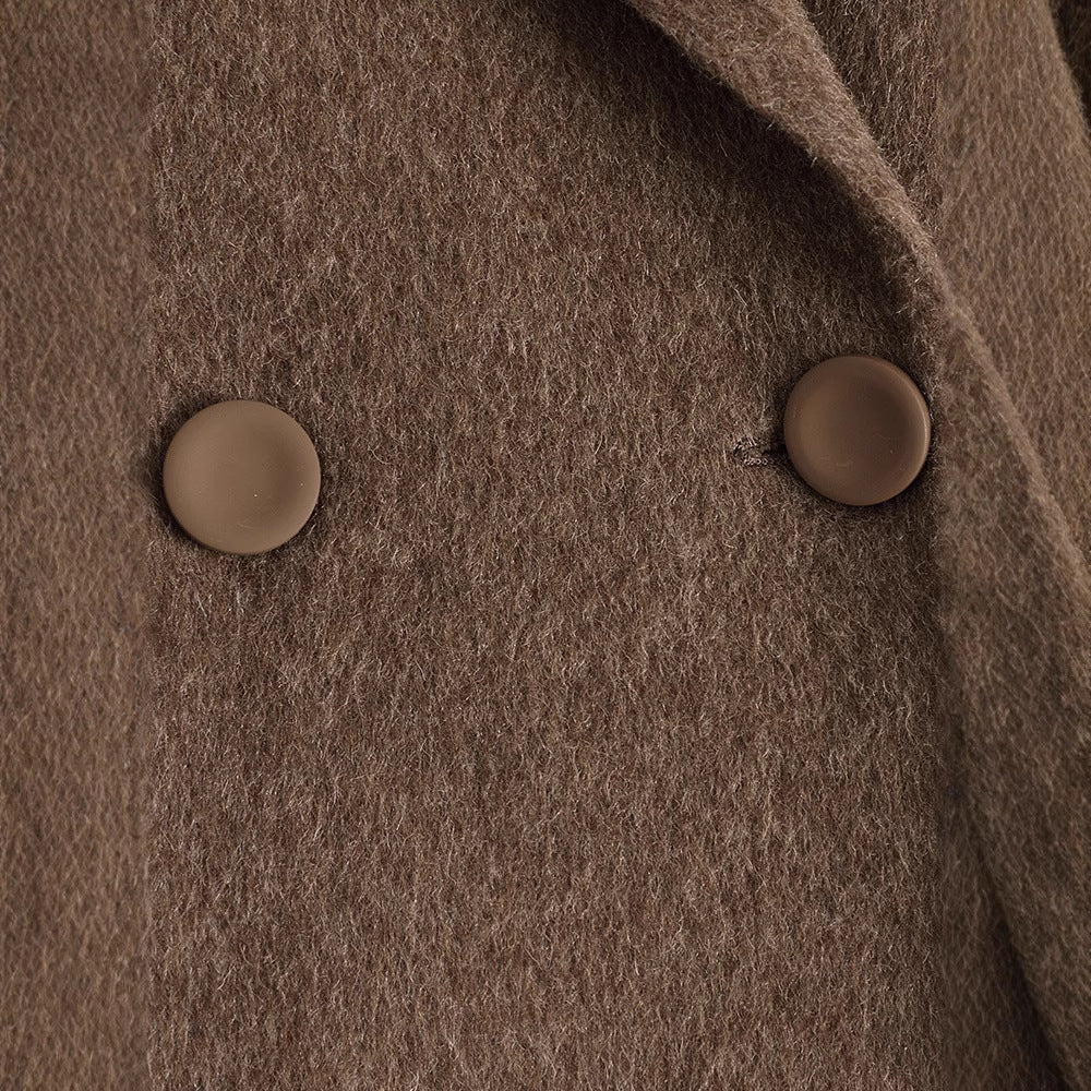 Close-up of a brown textured fabric with two buttons.