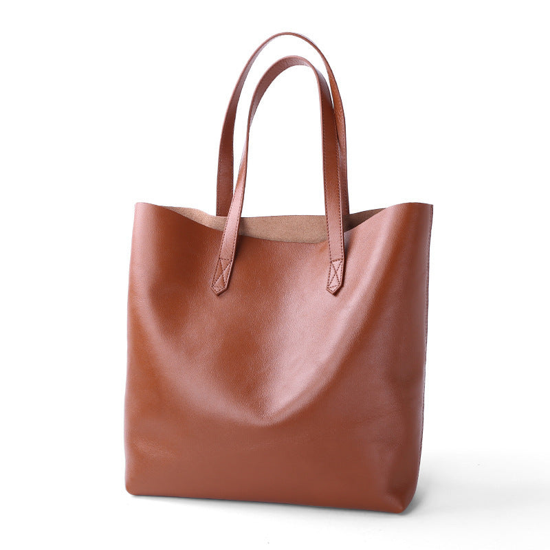 Brown leather tote bag on a white background