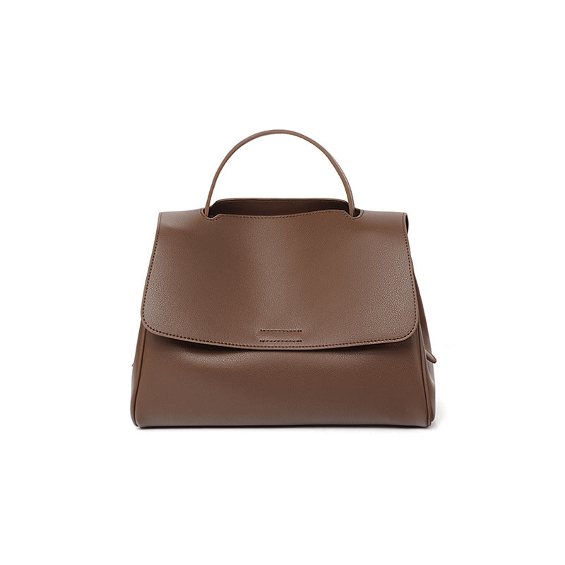 Brown leather handbag on a white background