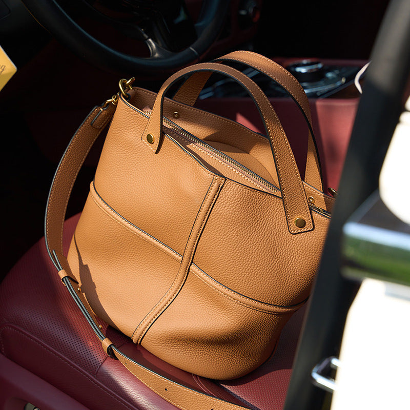 Brown leather handbag on a car seat