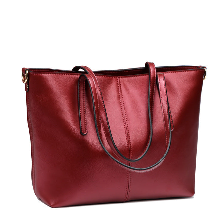 Red leather handbag on a white background