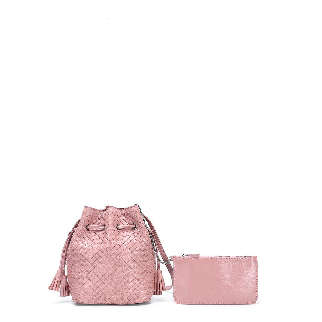 Pink woven handbag with matching pouch on a white background