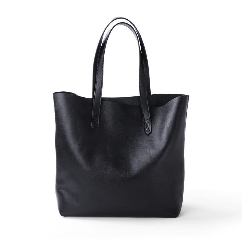 Black leather tote bag on a white background