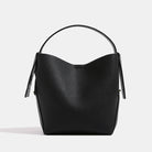 Black leather handbag on a light gray background