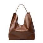 Brown leather handbag on a white background