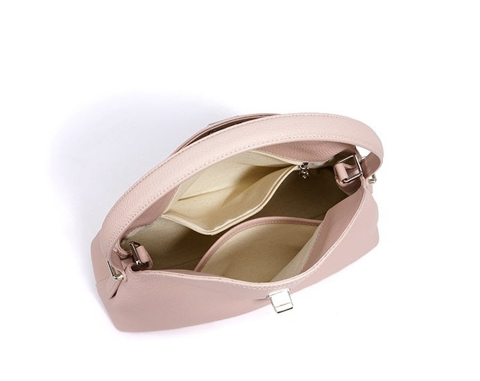 Pink handbag with gold interior on a white background
